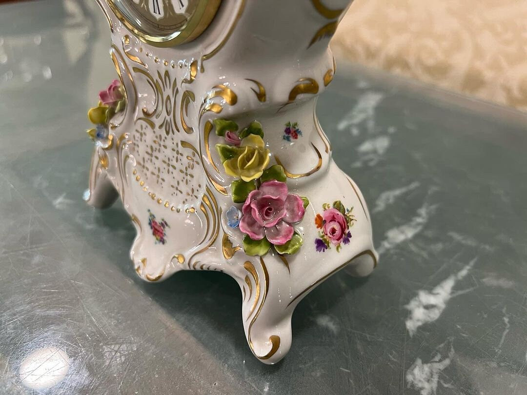 Antique Capodimonte Porcelain Quartz Clock with floral design in immaculate condition on display