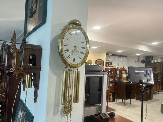 Antique Hermle wall clock in perfect condition displayed in a collector's room