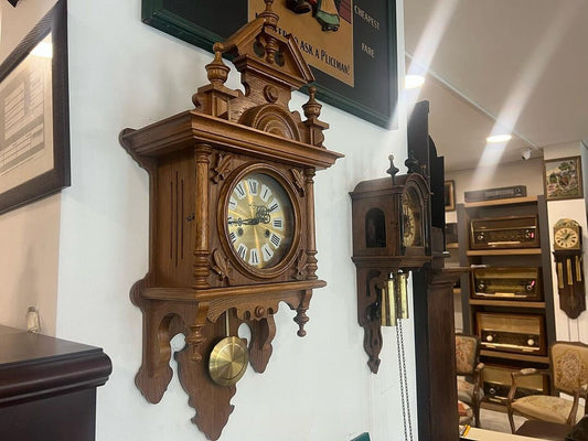 Collectible antique German Metron solid wood wall clock in perfect condition displayed in a classic room