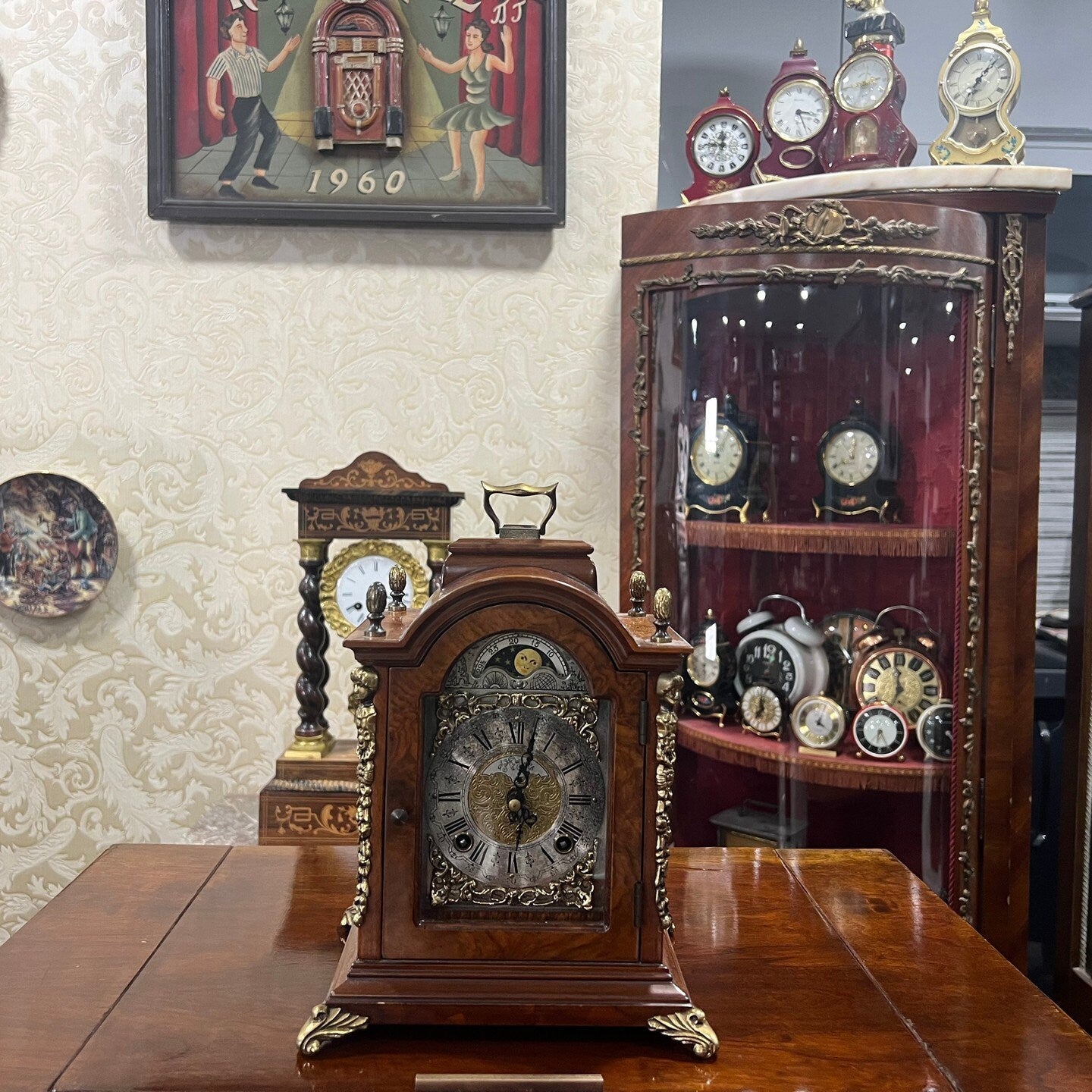 Antique Hermle Double Wind Wood Mantel Clock on Display with Other Collectible Timepieces