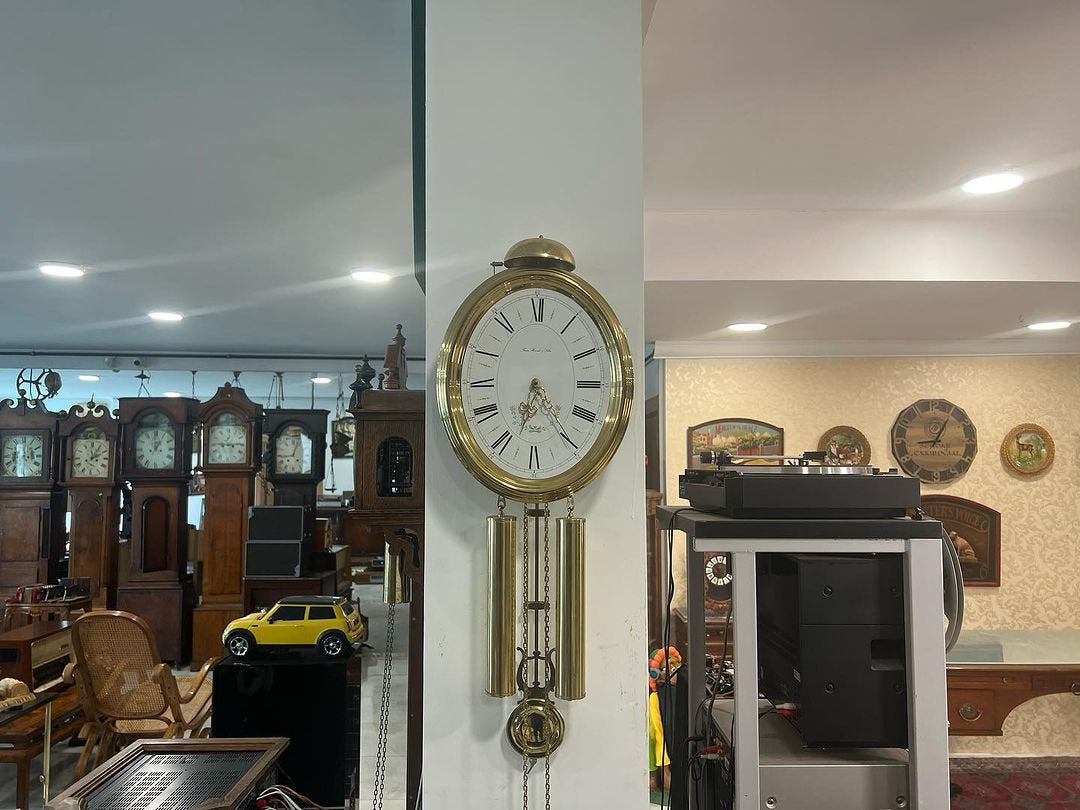 Collectible Antique Hermle Wall Clock in a showroom, showcasing elegant design and craftsmanship